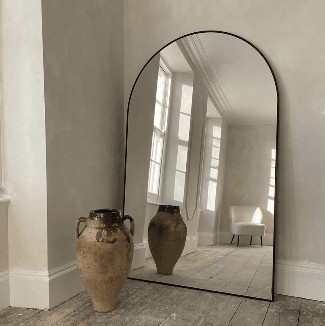 Large arched mirrors add an artistic touch to your home